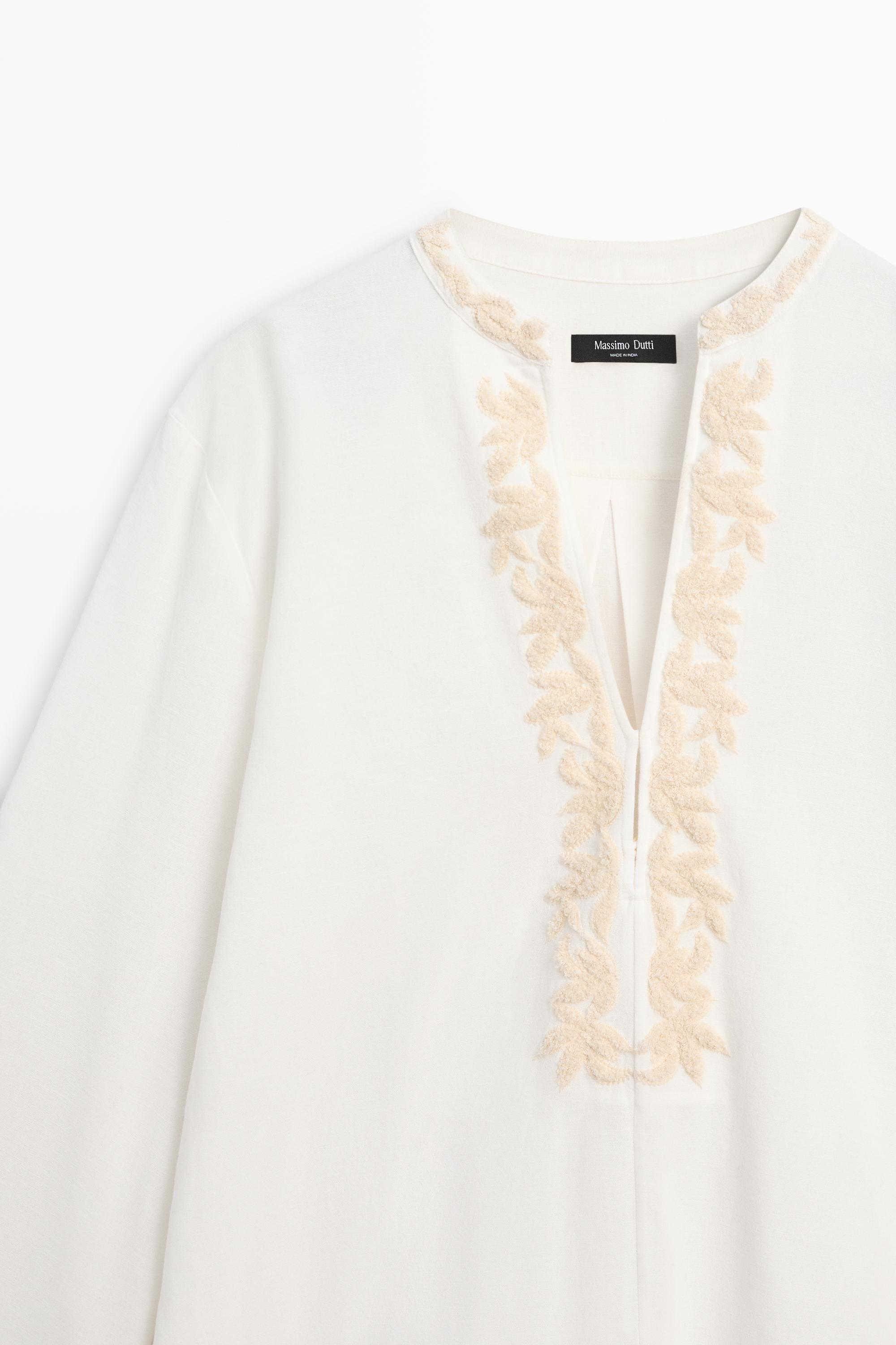 Flowing oversize blouse with stand collar and embroidery